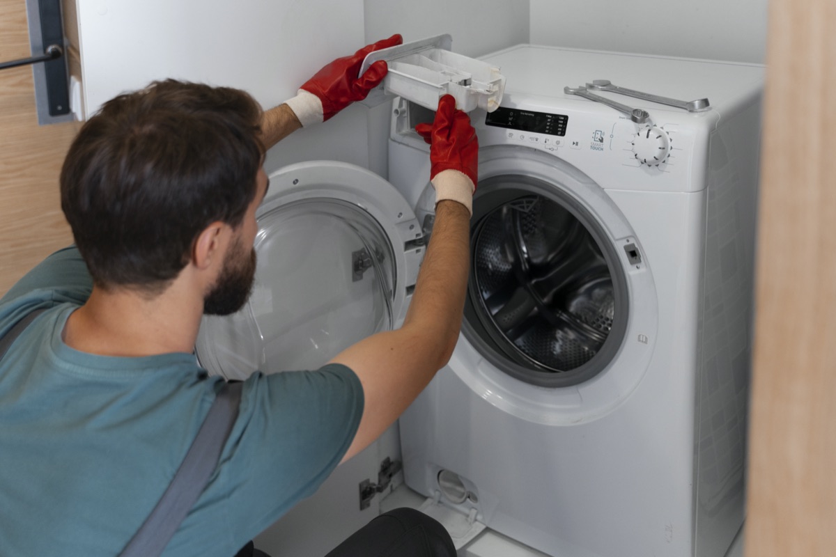 Technician servicing a washing machine